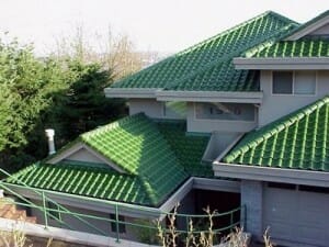 A green clay tile roof on a home.